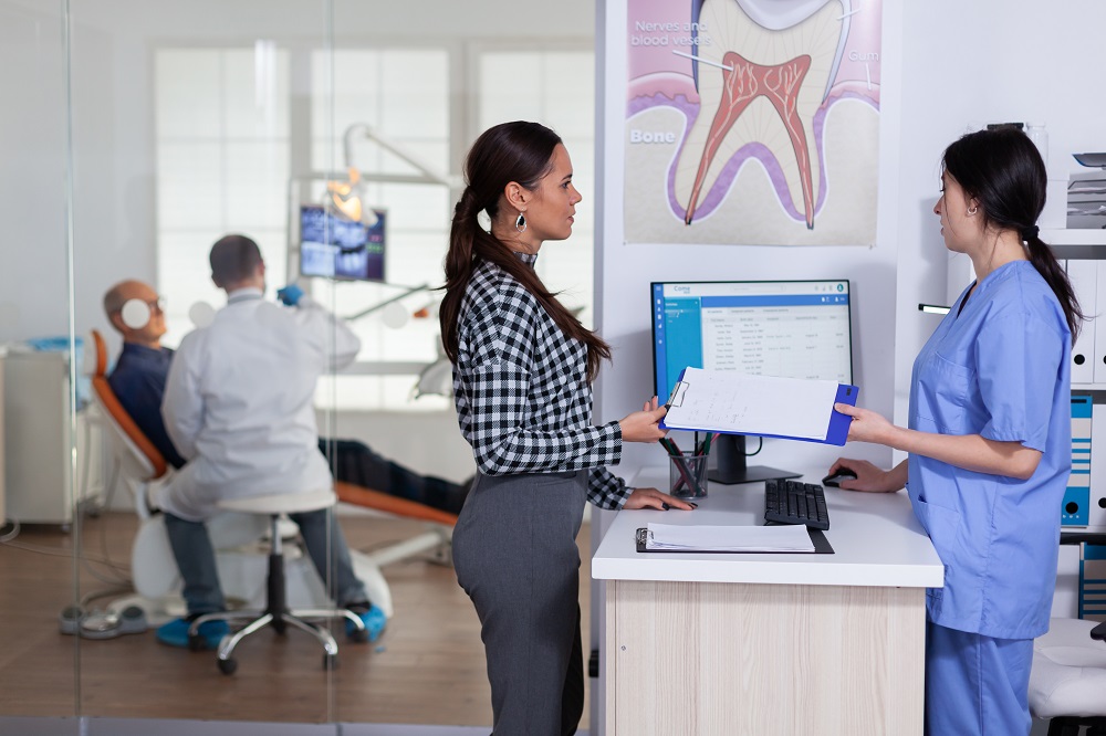 Patient completing dental office paperwork at Sunrise Dental Clinic in Gig Harbor, WA for a smooth, organized visit